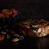 Apricot, date and almond fruit wheel with bowl of dried apricots and nuts