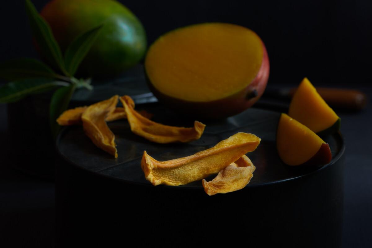 dried mango slices on a plate with fresh mango dried mango slices on a plate with fresh mango